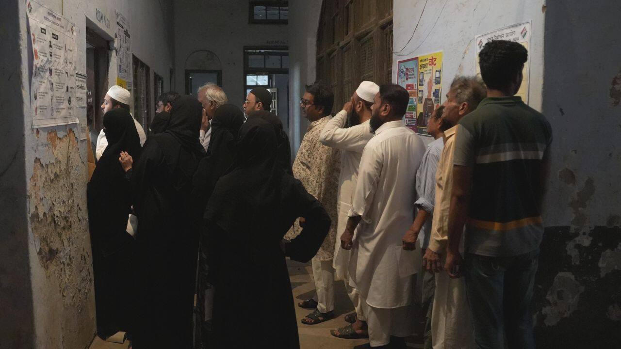 People wait in queues at a polling station to cast their votes during the fourth phase of Lok Sabha elections, in Kanpur, Monday, May 13, 2024. Polling is underway in Uttar Pradesh's 13 seats in fourth phase of Lok Sabha polls. (PTI Photo/Arun Sharma)