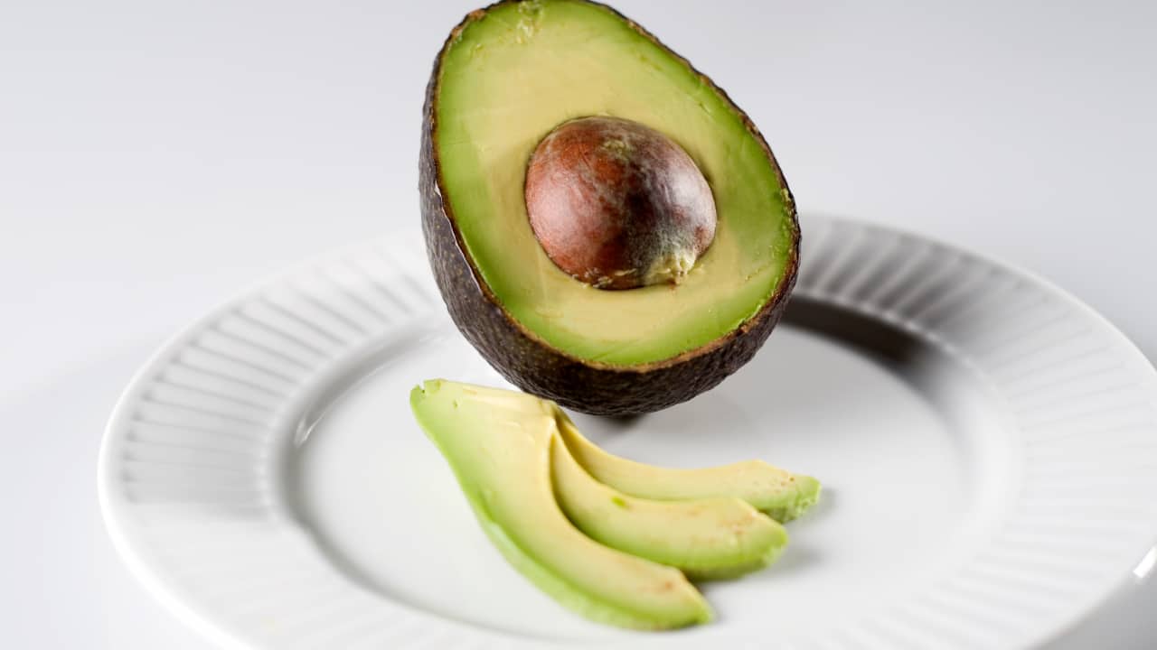 Avocado: Avocados are rich in monounsaturated fats and vitamins E and C, which are essential for maintaining skin elasticity and hydration. The healthy fats in avocados help to keep the skin's lipid barrier intact, while antioxidants fight oxidative stress, reducing the appearance of fine lines and wrinkles and promoting a youthful complexion. (Image: Canva)