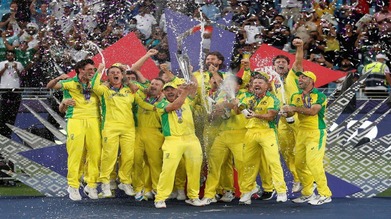 Cricket - ICC Men's T20 World Cup Final - New Zealand v Australia- Dubai International Cricket Stadium, Dubai, United Arab Emirates - November 14, 2021 Australia captain Aaron Finch celebrates with the trophy and teammates after winning the ICC Men's T20 World Cup REUTERS/Hamad I Mohammed TPX IMAGES OF THE DAY Cricket - ICC Men's T20 World Cup Final - New Zealand v Australia- Dubai International Cricket Stadium, Dubai, United Arab Emirates - November 14, 2021 Australia captain Aaron Finch celebrates with the trophy and teammates after winning the ICC Men's T20 World Cup REUTERS/Hamad I Mohammed TPX IMAGES OF THE DAY