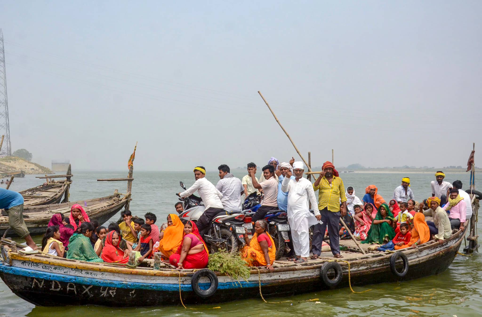 Inked and afloat: Patna voters cross Ganga after casting votes (PTI Photo)
