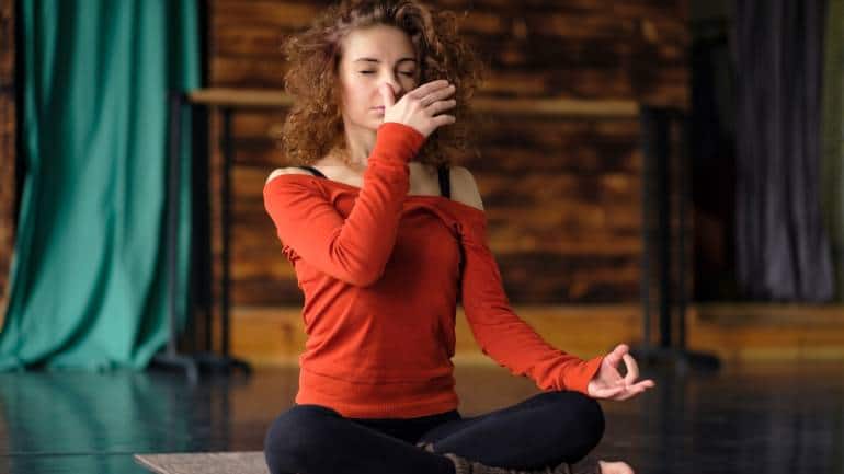 Alternate nostril breathing (Nadi shodhana): This pranayama technique involves closing one nostril and breathing through the other, then switching sides. It balances the left and right hemispheres of the brain, promoting mental clarity and emotional stability. This practice is highly effective in reducing stress and anxiety, enhancing overall mental health. Always ensure to consult with a yoga instructor and your physician before starting any yoga practice, especially if you have underlying health conditions (Image: Canva)