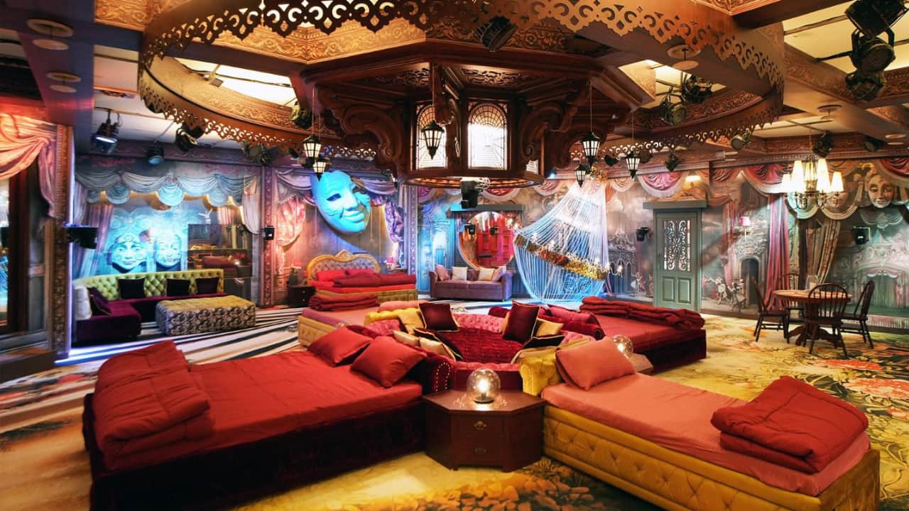 The bedroom, resembling a time-warped theatre, features silhouette cutout backdrops and uniquely placed beds to encourage interaction and bonding among housemates. 