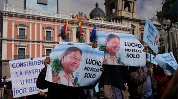Supporters of Bolivian President Luis Arce hold signs that read in Spanish, "Lucho you are not alone" during a march in support of the government, in La Paz, Bolivia, June 17, 2024.