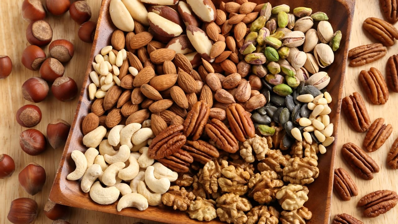 Nuts: Almonds, walnuts, and other nuts are packed with healthy fats, protein, and fiber. They provide sustained energy and contain mood-boosting nutrients like magnesium and zinc. (Image: Canva)