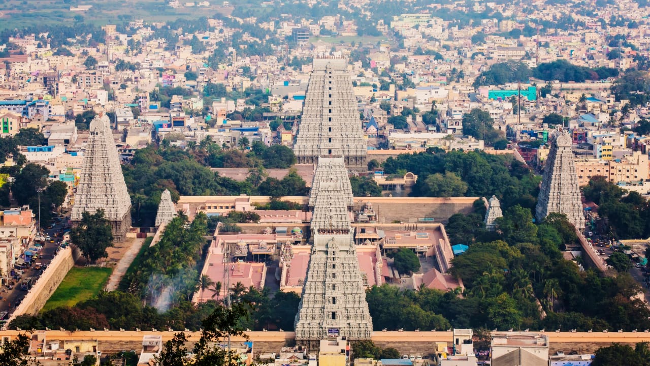 Tiruvannamalai, Tamil Nadu Tiruvannamalai, located in Tamil Nadu, holds significance as a place of great spiritual energy. Home to the Arunachaleswarar Temple dedicated to Lord Shiva, Tiruvannamalai is believed to be one of the Pancha Bhoota Sthalas (five elements temples), representing the fire element. It is closely associated with the Advaita philosopher Ramana Maharshi, who attained spiritual enlightenment here. Devotees visit to circumambulate the sacred Arunachala Hill and seek blessings for spiritual awakening and liberation. [Image: Canva]