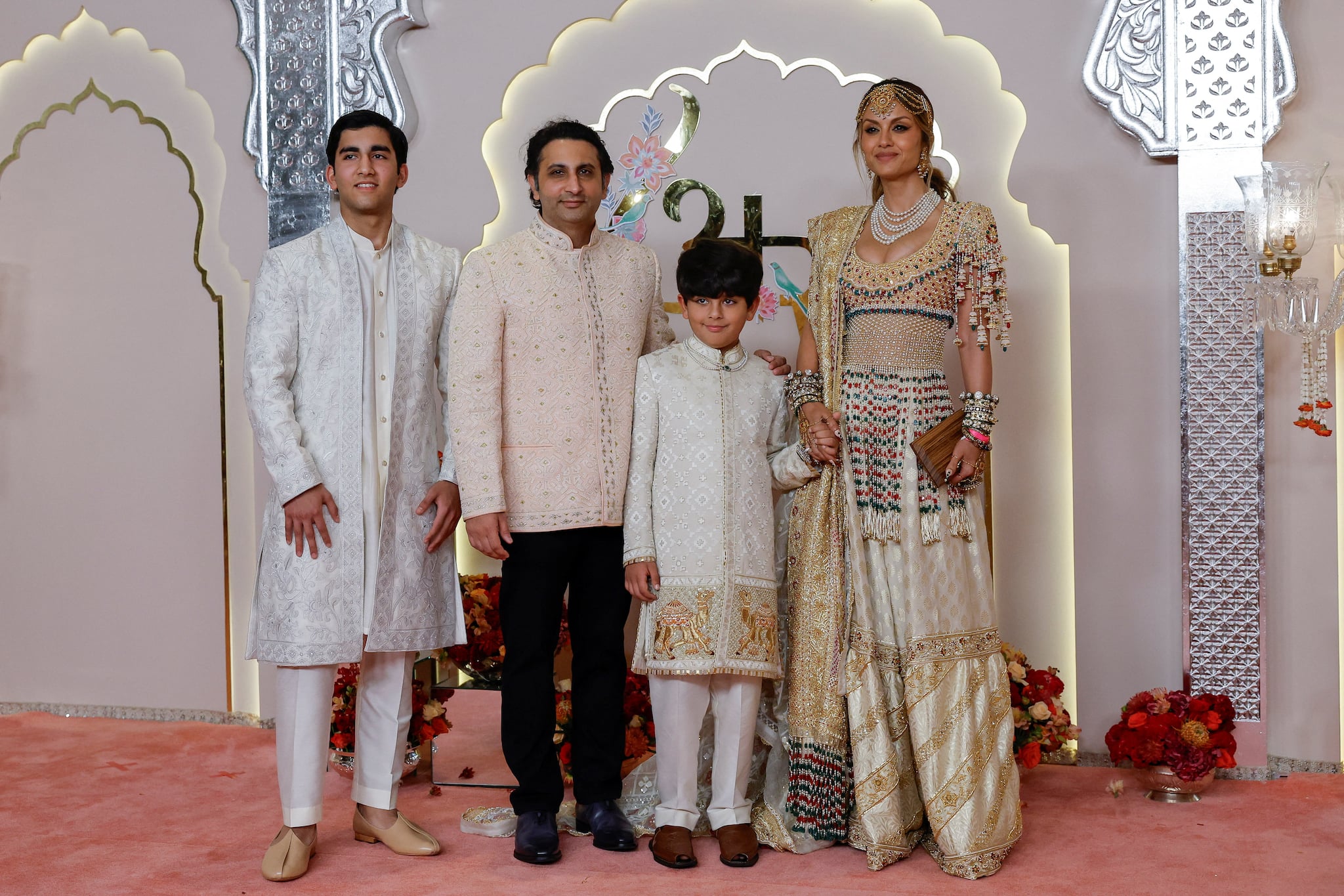 CEO of the Serum Institute of India Adar Poonawalla, his wife Natasha Poonawalla and their children Cyrus Poonawalla and Darius Poonawalla pose for pictures on the red carpet on the day of the wedding of Anant Ambani and Radhika Merchant in Mumbai, India, July 12, 2024. REUTERS/Francis Mascarenhas