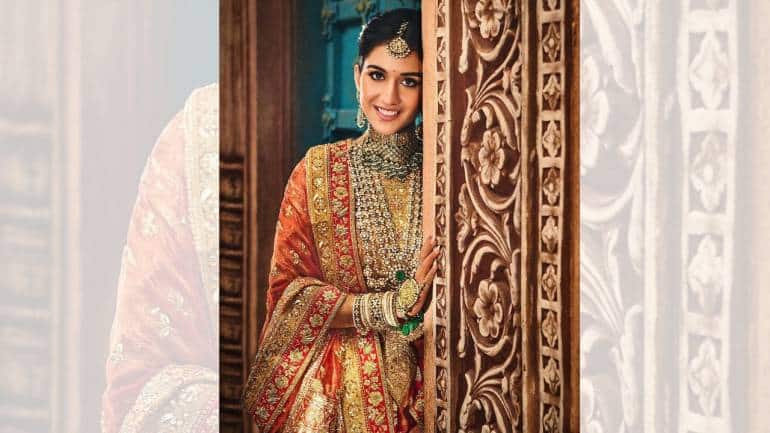 Red haute in Manish Malhotra: For her vidaai ceremony, Radhika Merchant stunned in a custom-made, sunset-hued Banarasi brocade lehenga by the celebrated designer Manish Malhotra. This outfit was a masterful blend of traditional craftsmanship and contemporary fashion, embodying the deep, regal legacy of India (Image: @manishmalhotraworld, @manishmalhotravows/Instagram)