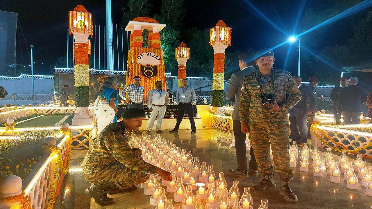 Kargil: Army personnel light candles at the Drass War Memorial during 'Shaurya Sandhya', organised to commemorate the 545 martyrs of Kargil war, on the eve of 25th Kargil Vijay Diwas celebrations, at Drass, in Kargil, Thursday, July 25, 2024. (PTI Photo) (PTI07_25_2024_000458B) Kargil: Army personnel light candles at the Drass War Memorial during 'Shaurya Sandhya', organised to commemorate the 545 martyrs of Kargil war, on the eve of 25th Kargil Vijay Diwas celebrations, at Drass, in Kargil, Thursday, July 25, 2024. (PTI Photo) (PTI07_25_2024_000458B)