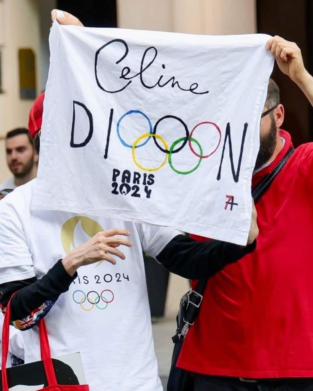 Fans hold up a poster as they look forward to Celine Dion's performance at the 2024 Olympics Opening Ceremony. (Image via Instagram/Celine Dion)