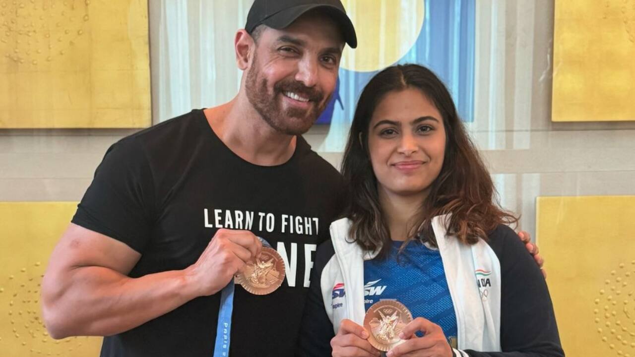 John Abraham poses with Manu Bhaker after she returns to India from Paris Olympics, shows off her bronze medal