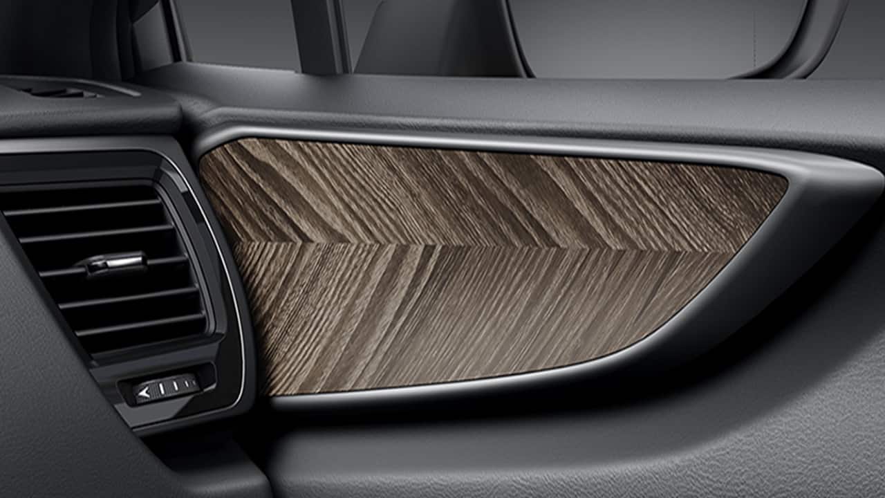 On the inside, you now get an all-black leather treatment along with organic-looking faux wooden trims above the doorpad