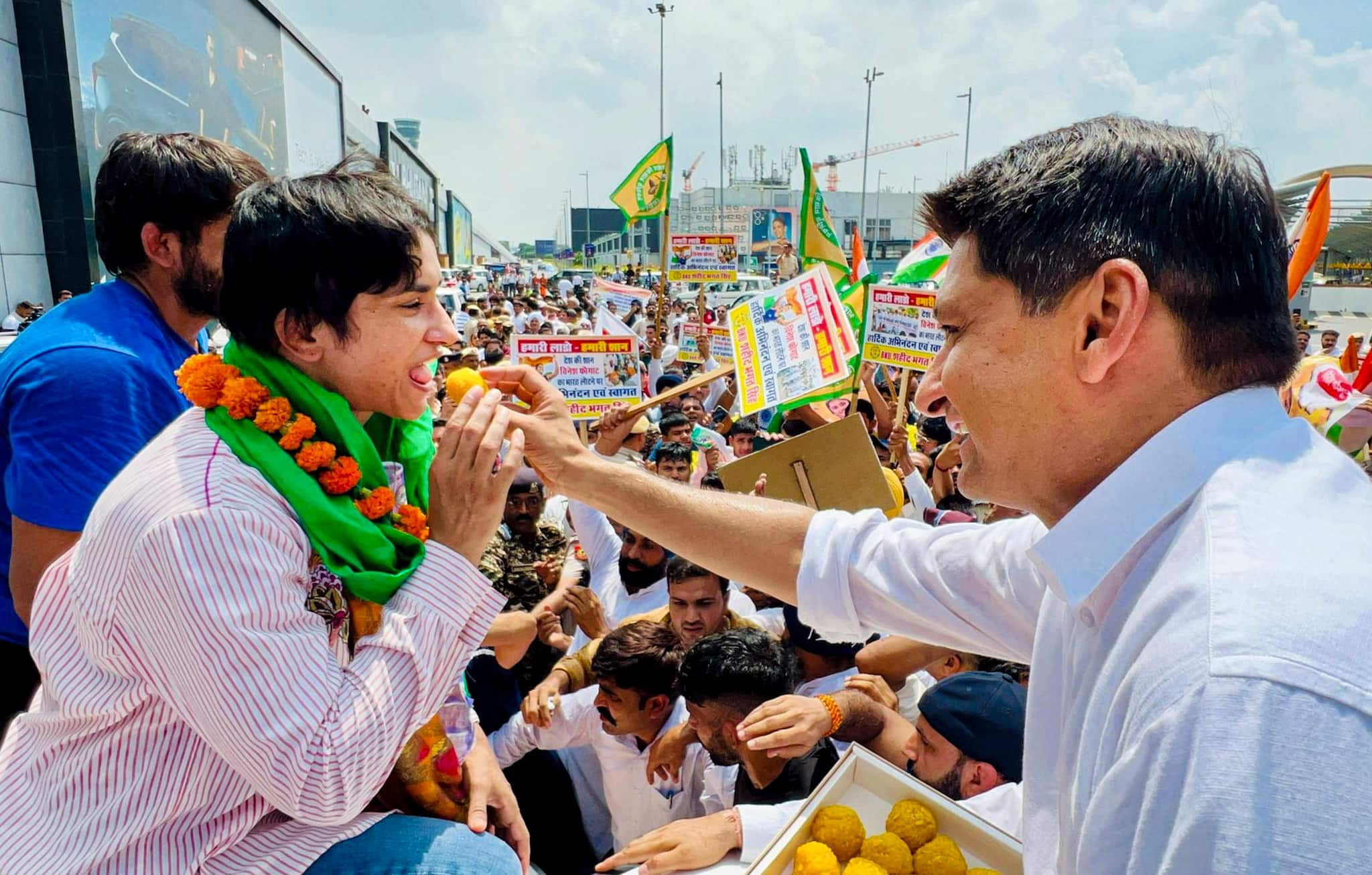 Congress leader Deepender Hooda accompanied Vinesh and offered her sweets, and presented a mace, a 'symbol of victory,' to Vinesh. (PTI Photo) 