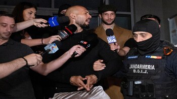 Andrew Tate and his brother Tristan are escorted outside the Directorate for Investigating Organized Crime and Terrorism (DIICOT), in Bucharest, Romania