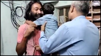 The child and his captor wept as police tried to separate them. (Image: screenshot from video @iamrehanu/X)