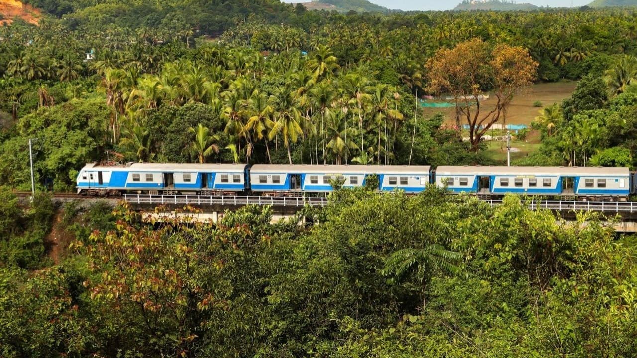 A MEMU train cuts through the serene emerald landscape as it moves along the tracks near Shiroor Railway Station, Karnataka, breaking the stillness of the lush green expanse. (Image: X/@RailMinIndia)