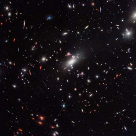 Wide Field View: The galaxy cluster MACS-J0417.5-1154 is so massive it is warping the fabric of space-time and distorting the appearance of galaxies behind it, an effect known as gravitational lensing. (Image: NASA)