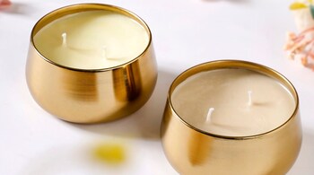 Outdoor festival lighting tips: Candles are a timeless addition to any festive décor. Opt for scented candles whenever possible (Image: Floral Gold Double Wick Scented Candle Set, Nestasia)