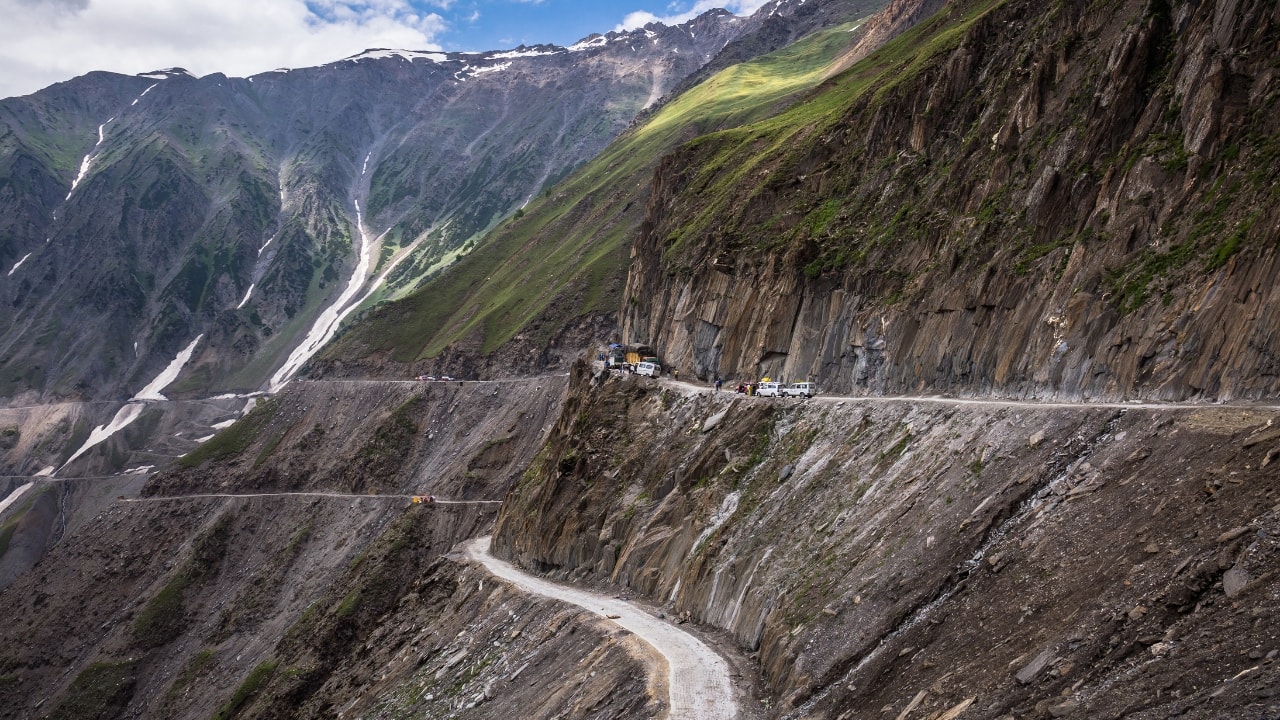 4. Zoji La Pass – Heart-Pounding Adventure One of the most dangerous and thrilling roads in the Himalayas, Zoji La is not for the faint-hearted! Nestled at 11,575 feet between Srinagar and Leh, this pass is a challenge with its narrow, winding roads and steep drops. But for adventure lovers, the ride through Zoji La is pure adrenaline, offering breathtaking views of the Kashmir Valley and the towering Himalayas. (Image: Canva) Best Time to Visit: May to June What’s Special: Heart-pounding curves with panoramic Himalayan views