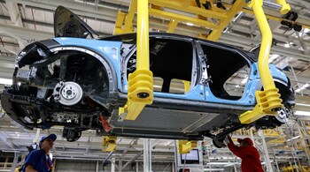 Workers assemble a BYD Dolphin compact hatchback electric vehicle inside the company’s new plant in Nikhom Phatthana, Thailand, in July. Bloomberg