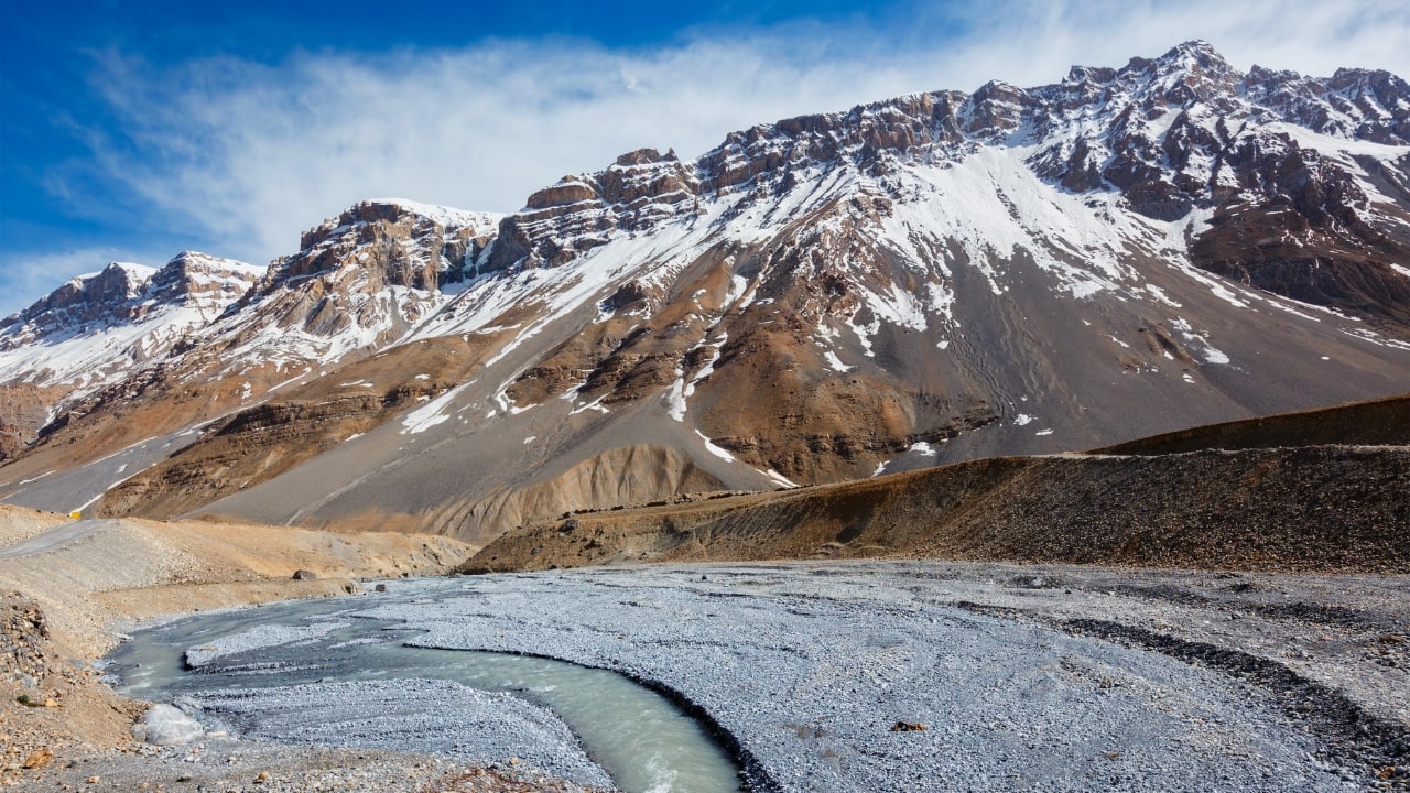 2. Spiti Valley, Himachal Pradesh: High-Altitude Serenity For those drawn to extreme landscapes, Spiti Valley offers a surreal high-altitude camping experience. Towering snow-capped peaks, barren yet beautiful landscapes, and ancient monasteries make Spiti a magical destination. Camp under the clearest night skies, witness shooting stars, and explore one of the coldest deserts in the world, where nature's raw beauty will take your breath away. (Image: Canva)