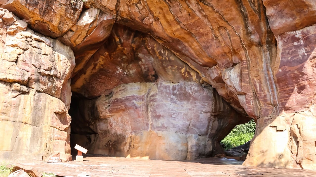 Bhimbetka Rock Shelters – Madhya Pradesh | These ancient rock shelters are home to prehistoric cave paintings that offer insight into early human life. A UNESCO World Heritage site, Bhimbetka provides a fascinating glimpse into India's ancient history.(Image: Canva)