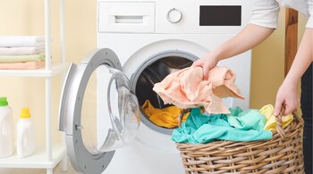 Wash heavier items like towels separately from lighter fabrics to ensure even cleaning and drying. (Image: Canva)