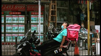 A delivery agent napping on his bike in China. (Representational)