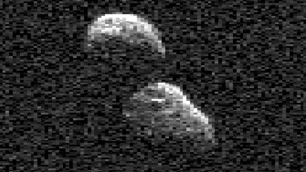 Snowman-shaped object hurdling past Earth; What is it?