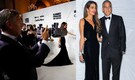 George Clooney can't hide his admiration as he snaps photos of wife Amal Clooney on the red carpet