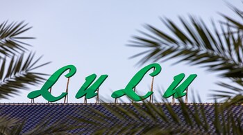A logo sits on display above a Lulu hypermarket, operated by Lulu Group International, during the coronavirus lockdown in Dubai, United Arab Emirates, on Thursday, April 23, 2020. An investment firm backed by a member of Abu Dhabis royal family agreed to buy a stake worth just over $1 billion in LuLu Group International, which runs one of the Middle Easts largest hypermarket chains, according to people familiar with the matter. Photographer: Christopher Pike/Bloomberg