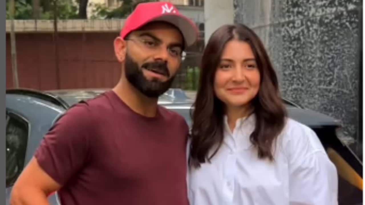 Anushka Sharma and Virat Kohli pose for paparazzi, latter clicks a pic with lady fan