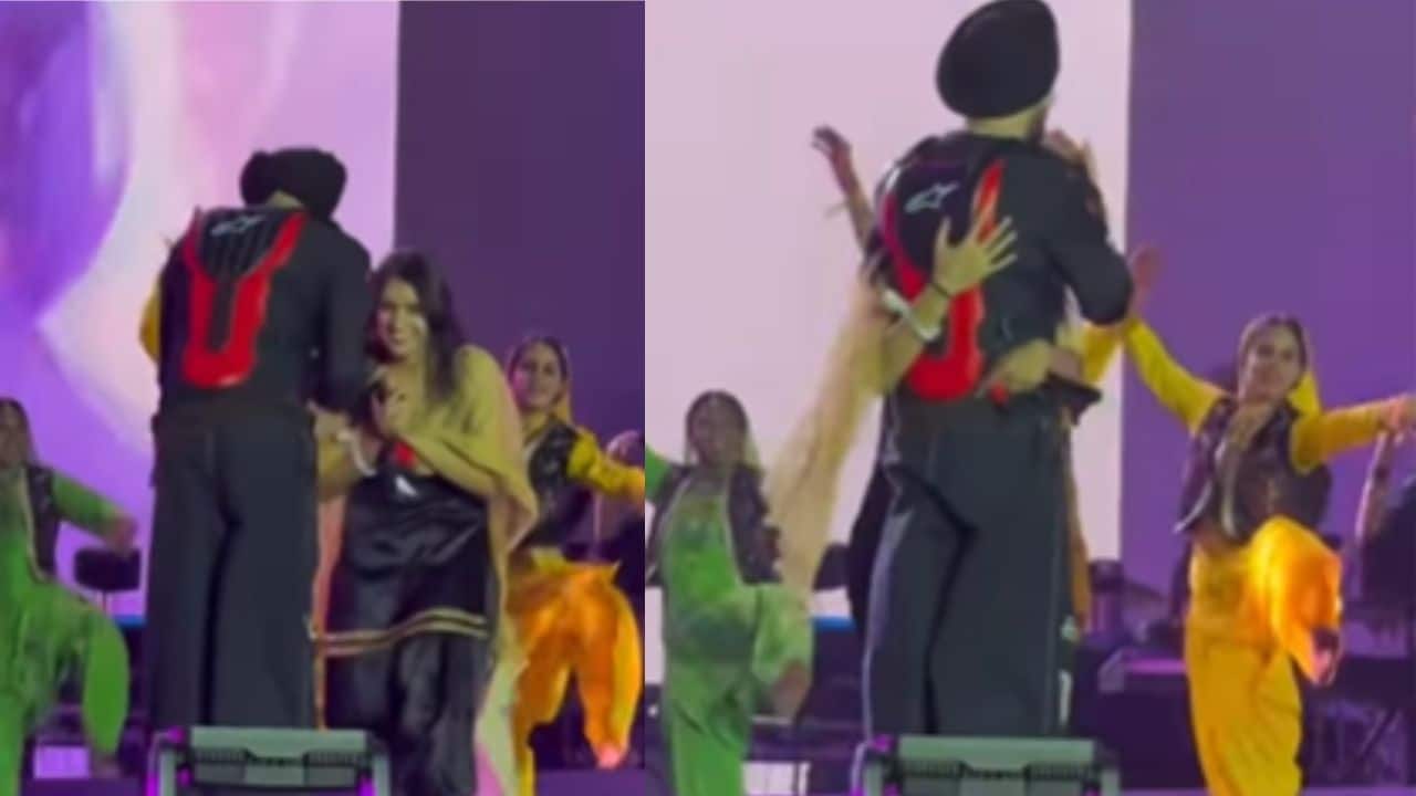 Diljit Dosanjh turns red with a smile after a girl in black suit hugs him on stage