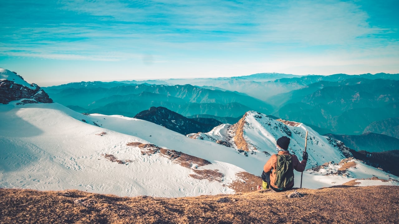 Snow-capped peaks and serene trails: Embark on an unforgettable winter trek in the Himalayas this December. (Image: Canva)