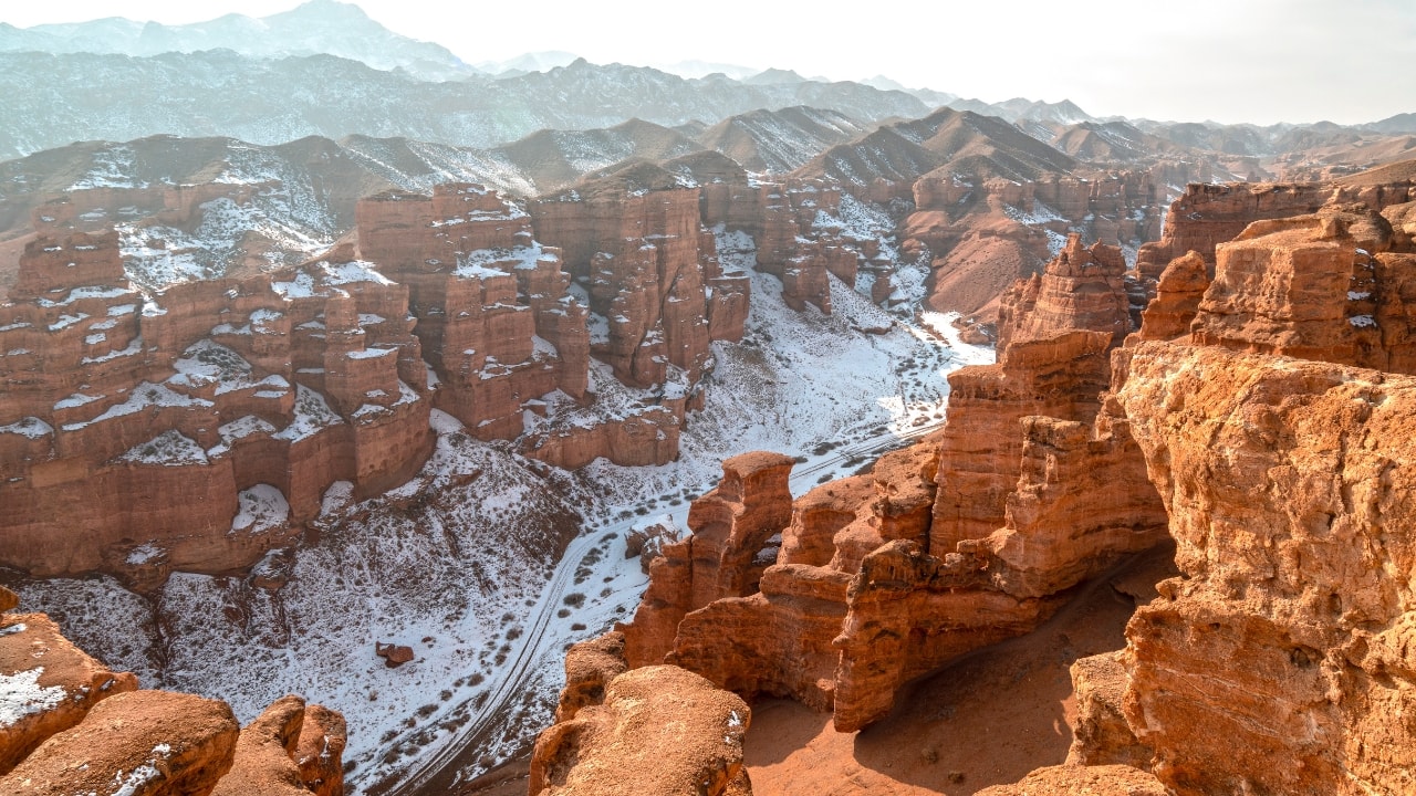 Charyn Canyon's vibrant rock formations, highlighted by a winter wonderland touch. (Image: Canva)