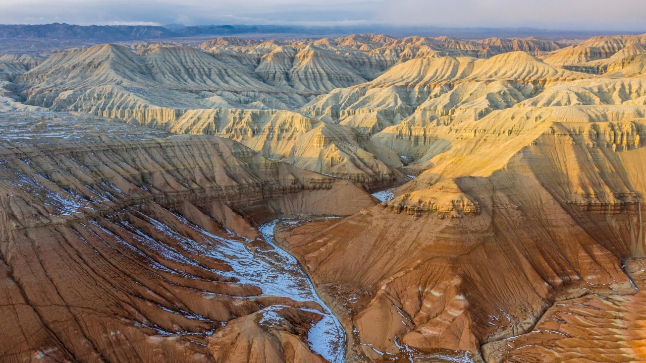 Dramatic rock formations surrounded by frost, creating a surreal winter wonderland. (Image: Canva)