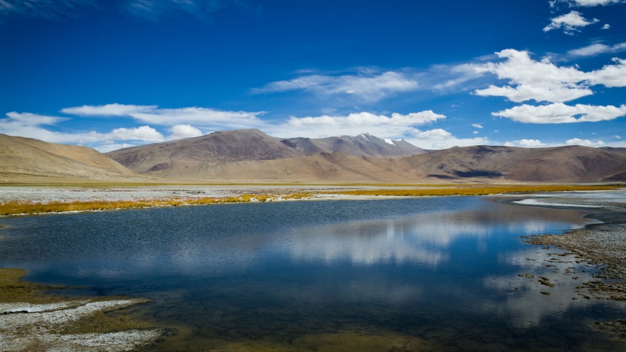 White salt marshes surrounded by snow-capped peaks create a peaceful, otherworldly charm. (Image: Canva)