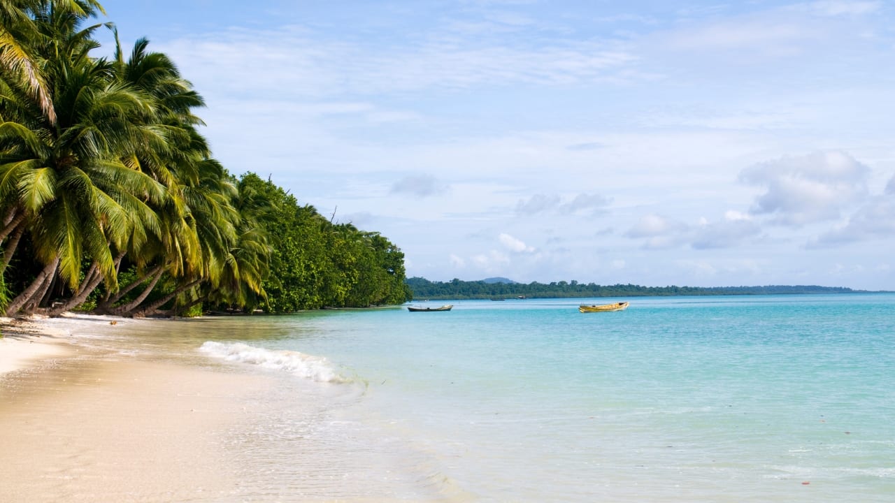 Crystal-clear waters and vibrant coral reefs make this island a tropical paradise. (Image: Canva)
