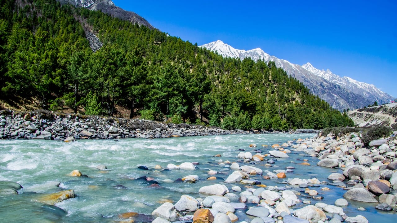 Discover India’s last village, where the Baspa River flows as calmly as time itself. (Image: Canva)