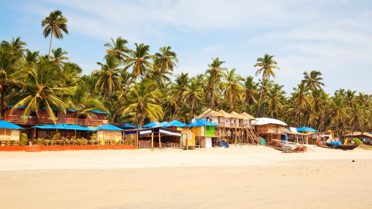 Relax on Goa's serene beaches and enjoy budget-friendly accommodations for the perfect girls' getaway. (Image: Canva)