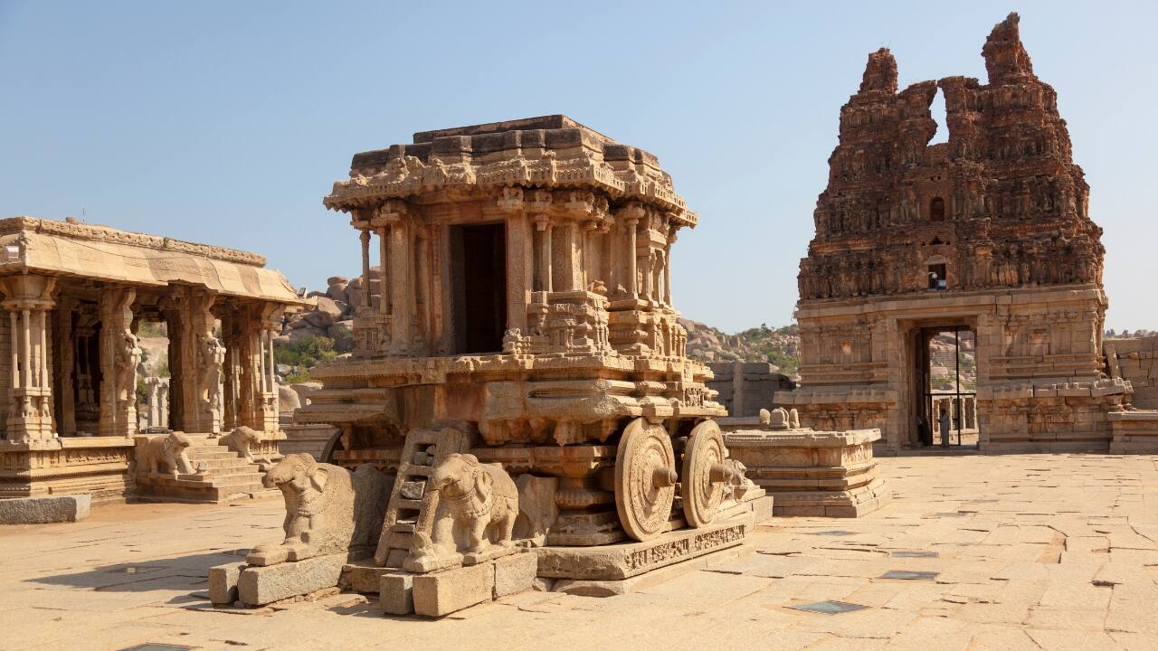 Wander through Hampi’s UNESCO ruins and temples, with affordable lodging and cultural exploration. (Image: Canva)