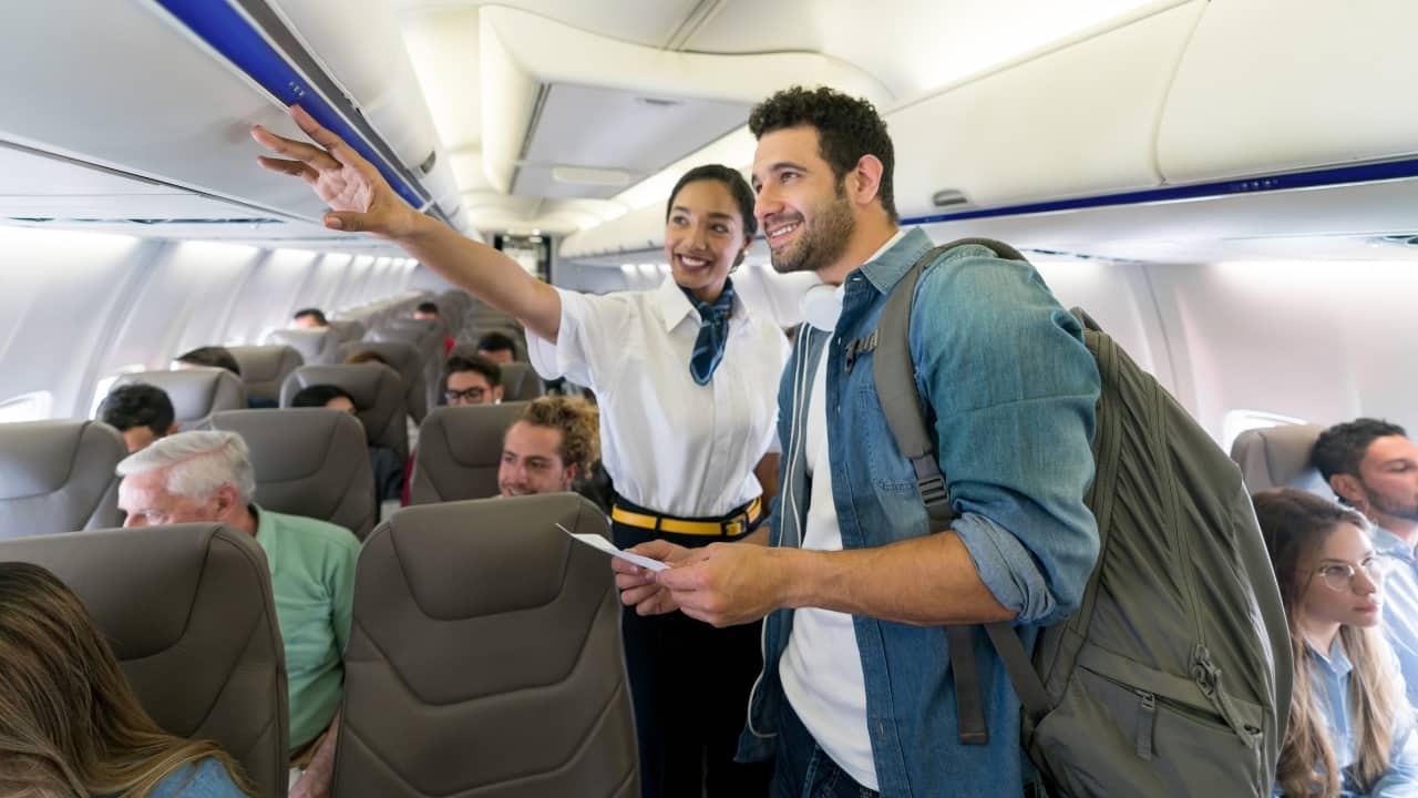 Caught in the act: Seat squatting on flights is becoming the new headache for passengers and airlines. (Image: Canva)