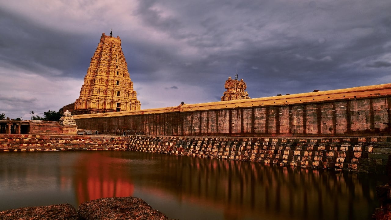 Stunning views of Hampi’s ancient temples against the backdrop of a clear, sunny sky. (Image: Canva)