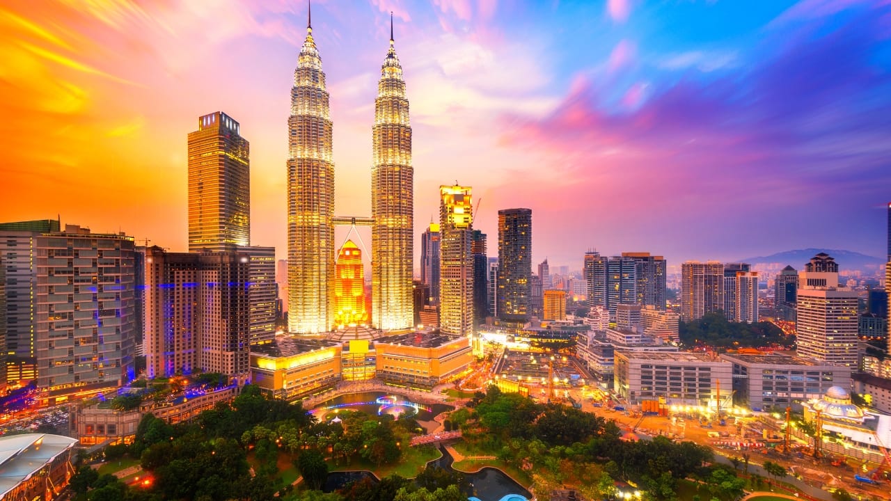 Experience Malaysia's dynamic mix of skyscrapers and rainforests, with 30 days of visa-free travel for Indian tourists. (Image: Canva)