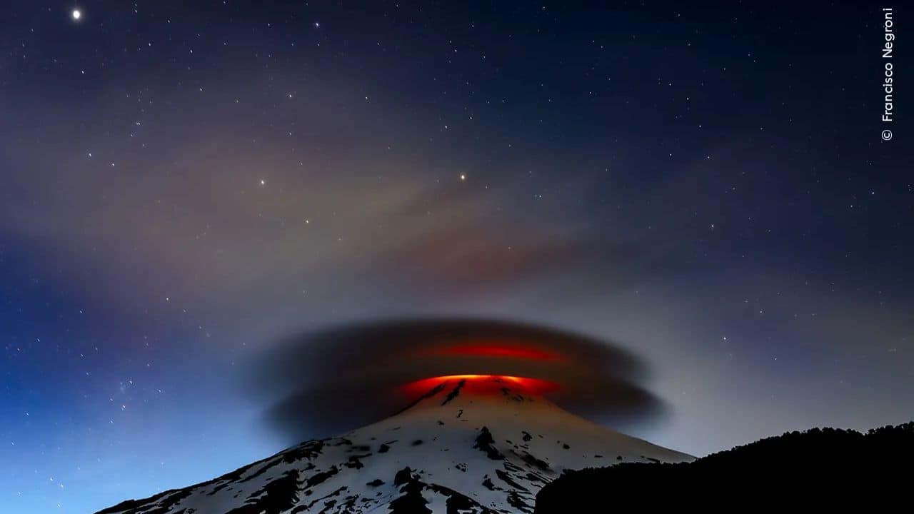 Francisco Negroni captured Villarrica volcano's fiery glow illuminating a rare double lenticular cloud at nightfall, showcasing the unpredictability of one of Chile's most active volcanoes. (Image: Natural History Museum)