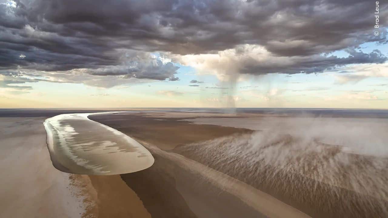 The Arrival: Brad Leue captures floodwaters channelling into Kati Thanda-Lake Eyre, South Australia, bringing life to the desert and its rare wildlife. (Image Credit: Natural History Museum)