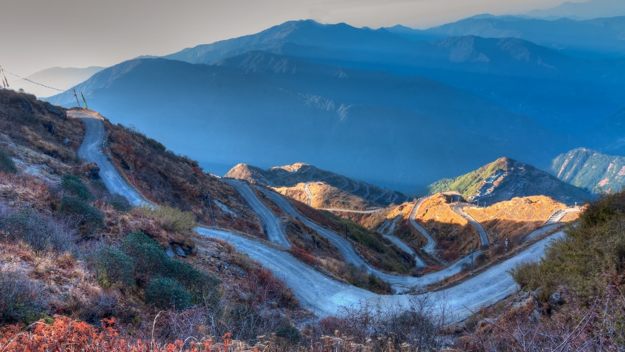 India’s borders are more than just boundaries; they are gateways to unique travel experiences. Whether you’re looking for adventure, history, or a peaceful escape, the destinations near India’s borders offer an enriching journey that you won't find anywhere else. From tranquil lakes to lively border ceremonies, here are 11 must-visit border destinations in India that should make it to your travel bucket list. (Image: Canva)