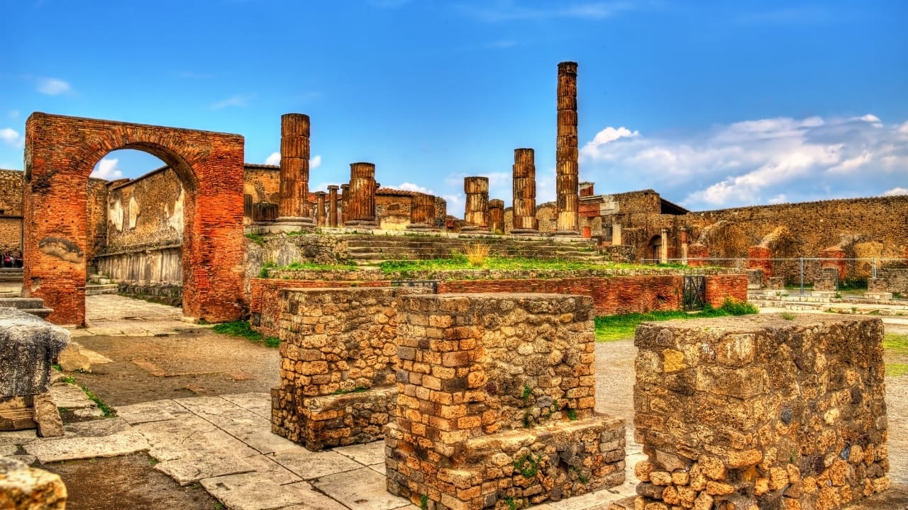 8. Pompeii and Mount Vesuvius Wander through the ancient ruins of Pompeii, a city frozen in time after the eruption of Mount Vesuvius in 79 AD. Explore its remarkably preserved streets, homes, and public spaces before embarking on a hike up the volcano that forever altered this ancient civilization. (Image: Canva)