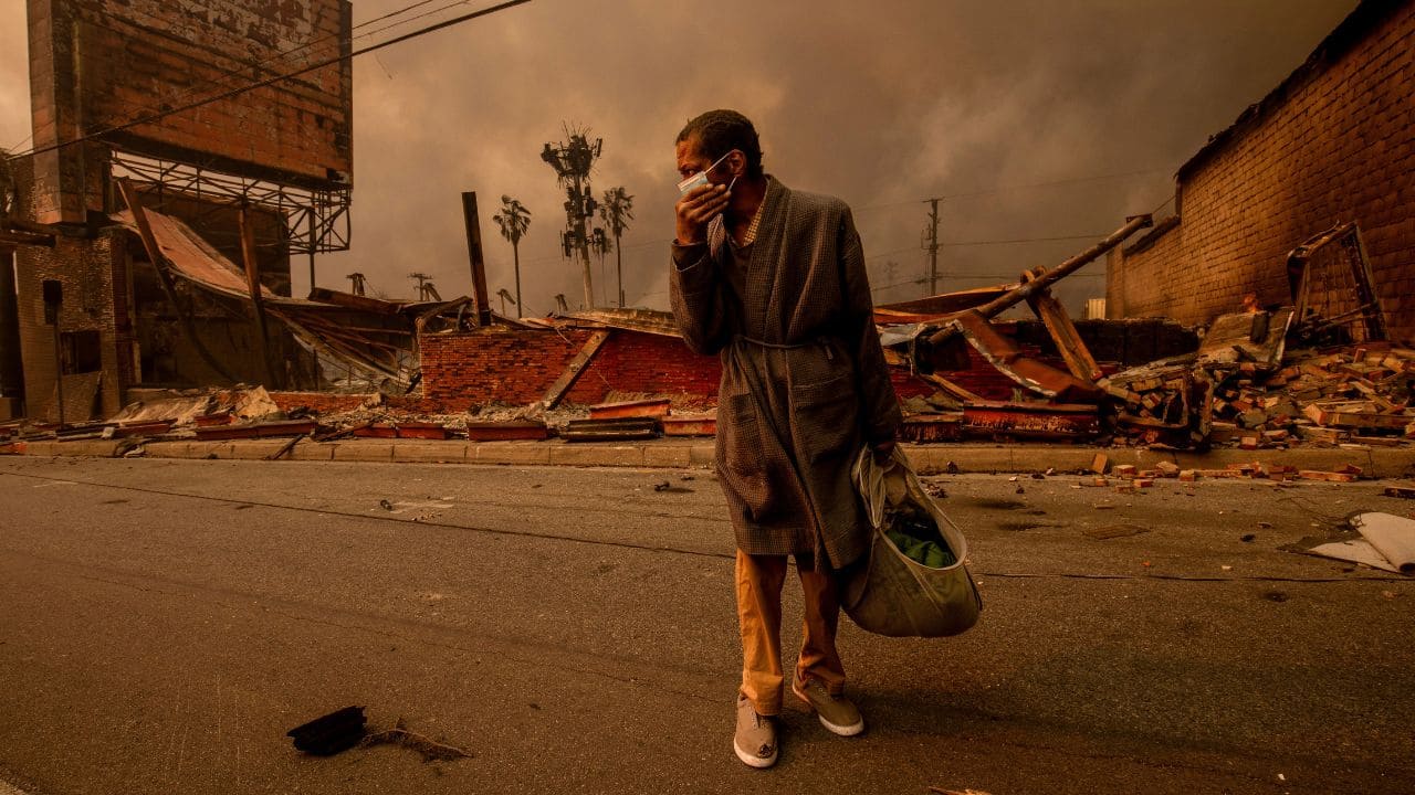 CALIFORNIA WILDFIRES 2025: A man walks past a business destroyed by the Eaton Fire in Altadena on Wednesday, Jan. 8, 2025.