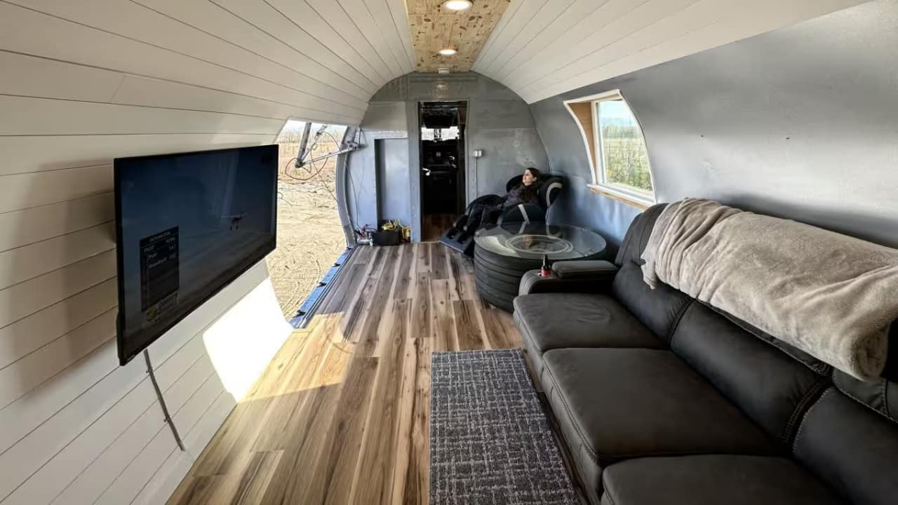 A Home with a View – Literally One of the standout features of this DC-6 airplane home is the stunning mountain views that surround it. The aircraft still has its working cargo door, which opens up to offer guests panoramic vistas of snow-covered peaks and towering forests. Imagine sipping your morning coffee while gazing out at the incredible Alaskan wilderness, or enjoying a sunset as the sky changes hues over the distant mountains. This is the kind of unique experience that sets this Airbnb apart from all others. (Image: Airbnb) A Home with a View – Literally One of the standout features of this DC-6 airplane home is the stunning mountain views that surround it. The aircraft still has its working cargo door, which opens up to offer guests panoramic vistas of snow-covered peaks and towering forests. Imagine sipping your morning coffee while gazing out at the incredible Alaskan wilderness, or enjoying a sunset as the sky changes hues over the distant mountains. This is the kind of unique experience that sets this Airbnb apart from all others. (Image: Airbnb)