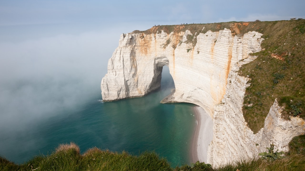 5. Etretat Cliffs, France The Etretat Cliffs in Normandy are famous for their unique natural arches and plunging drops into the English Channel. The rugged beauty and scenic hiking trails make it a must-see for nature lovers. (Image: Canva)